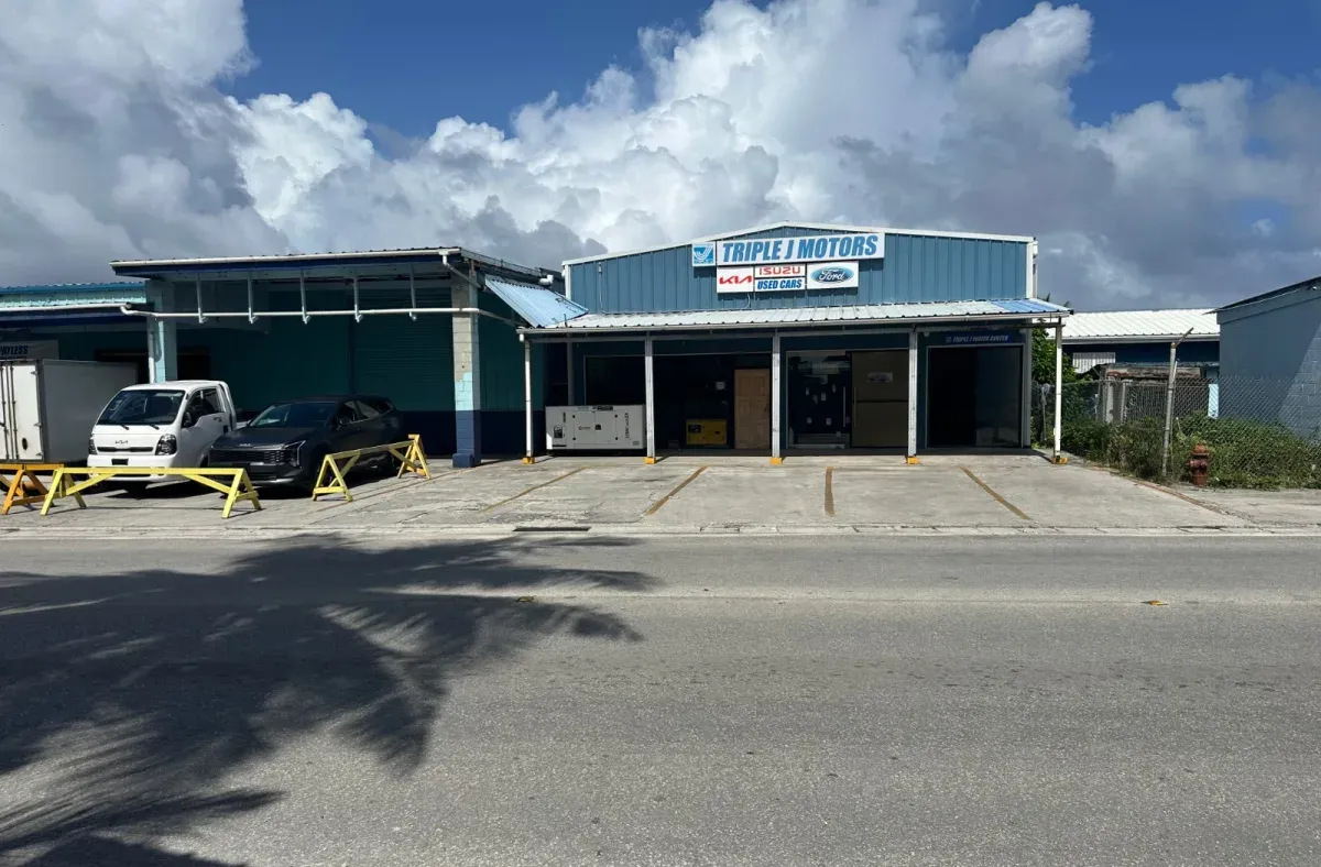 The Triple J Motors branch in Majuro, its roof sign listing Kia, Isuzu and Ford above the forecourt